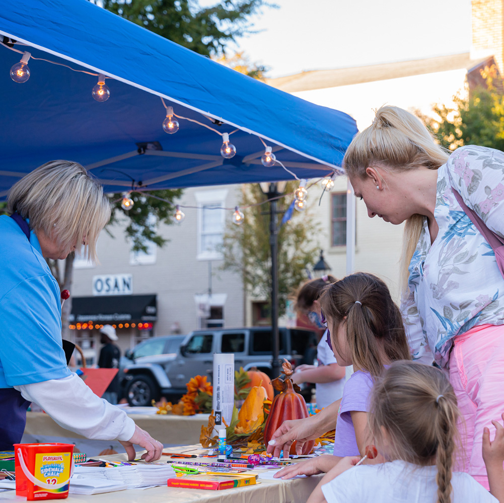 Mother and kids at arts booth at First Friday