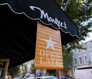 Orange Open Late banner hanging from Monkee's awning